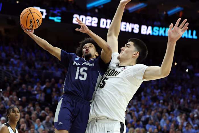 St. Peter's Peacocks guard Matthew Lee (15) shoots against Purdue Boilermakers center Zach Edey (15) in the second half in the semifinals of the East regional of the men's college basketball NCAA Tournament at Wells Fargo Center.